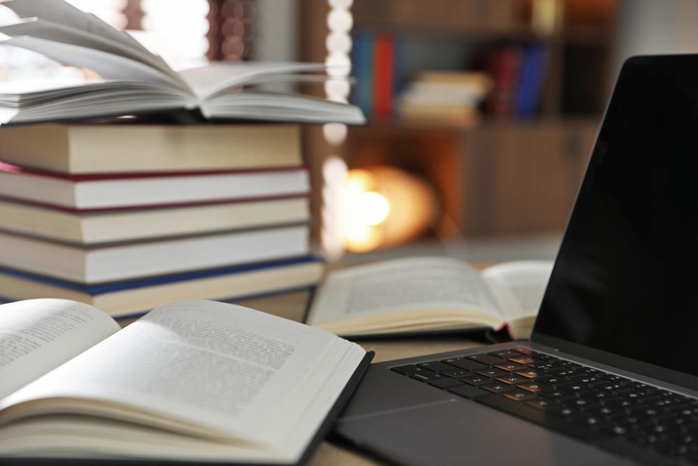 Many,Books,And,Laptop,On,Table,Indoors,,Closeup